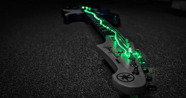 Guitar with glowing strings to represent power chords on guitar