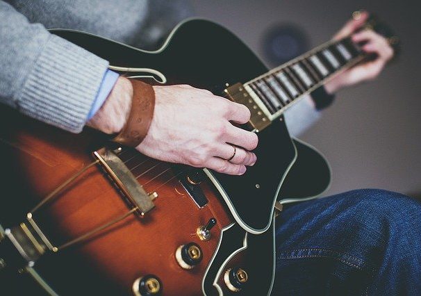 Man playing diminished chords on guitar